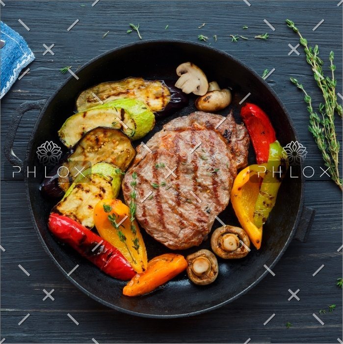 grilled beef steak on dark wooden table P4NLM25
